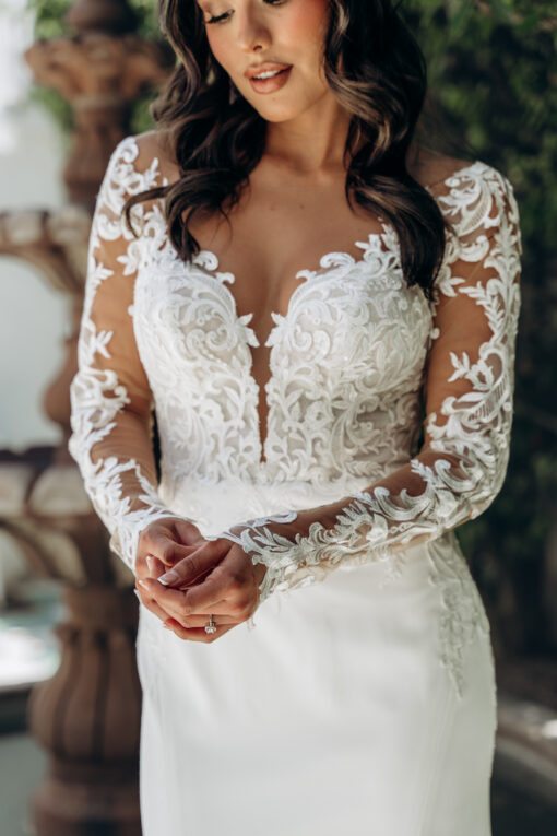 Elegant long‑sleeve lace fit‑and‑flare wedding dress, high illusion neckline, plunging bodice, low open back, trumpet skirt (Stella York 8028)