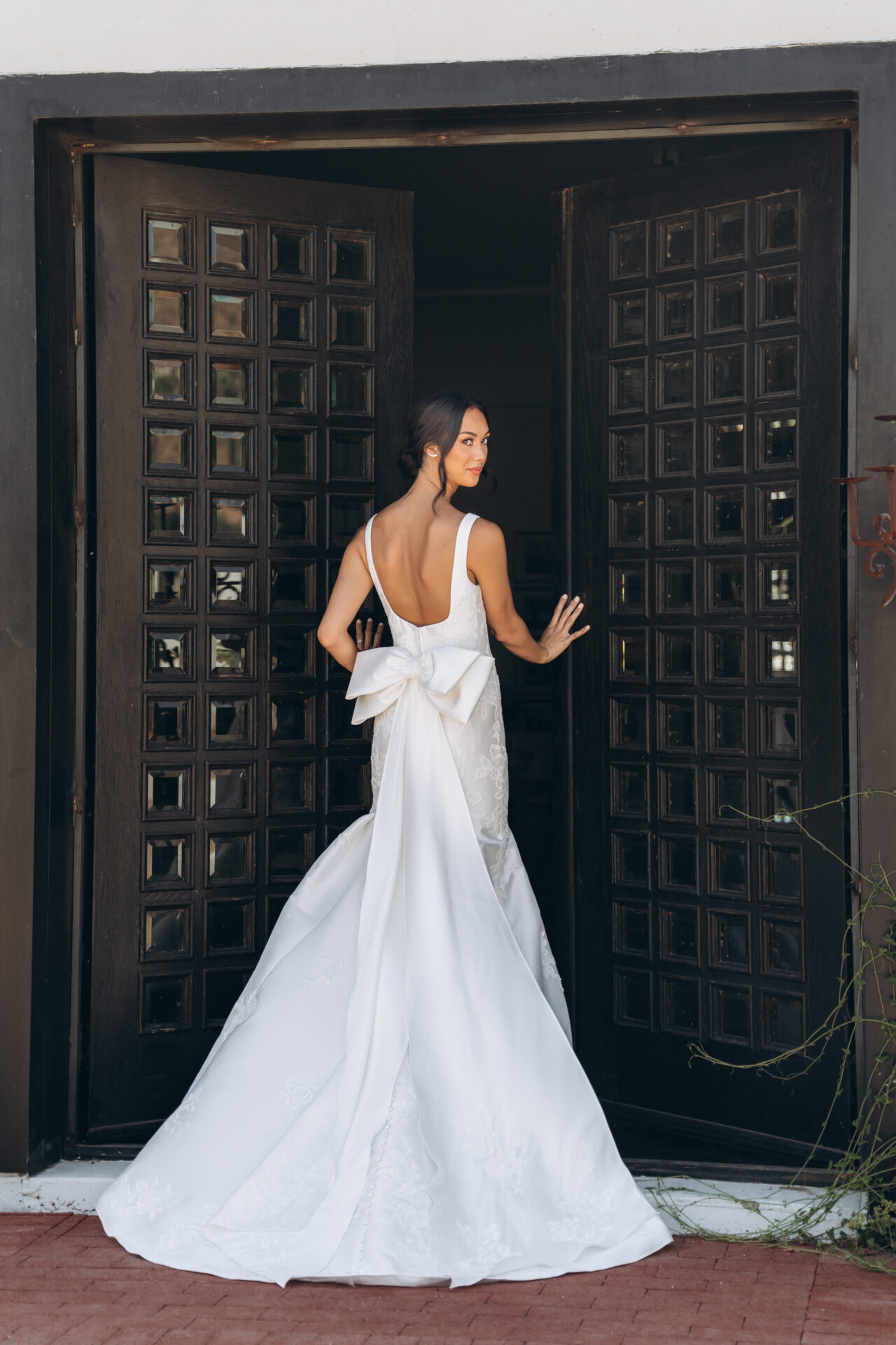 Stella York wedding gown Style 8047: elegant Mikado fit‑and‑flare with square neckline, optional matte floral lace, low scoop back and detachable oversized bow