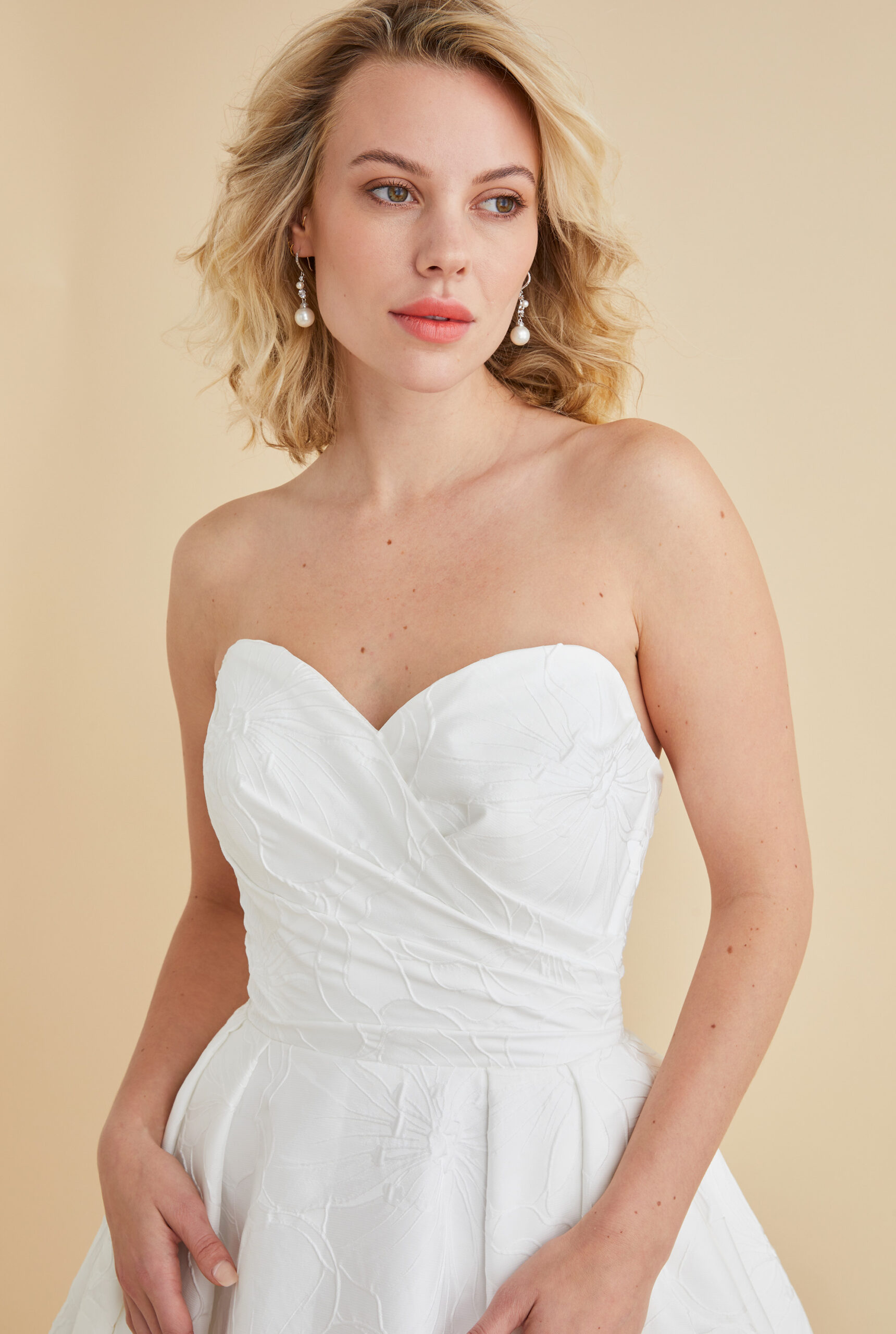 Astrid & Mercedes Aura wedding dress in hibiscus jacquard with ruched sweetheart bodice, low back, inverted-pleat full skirt, and chapel-length train