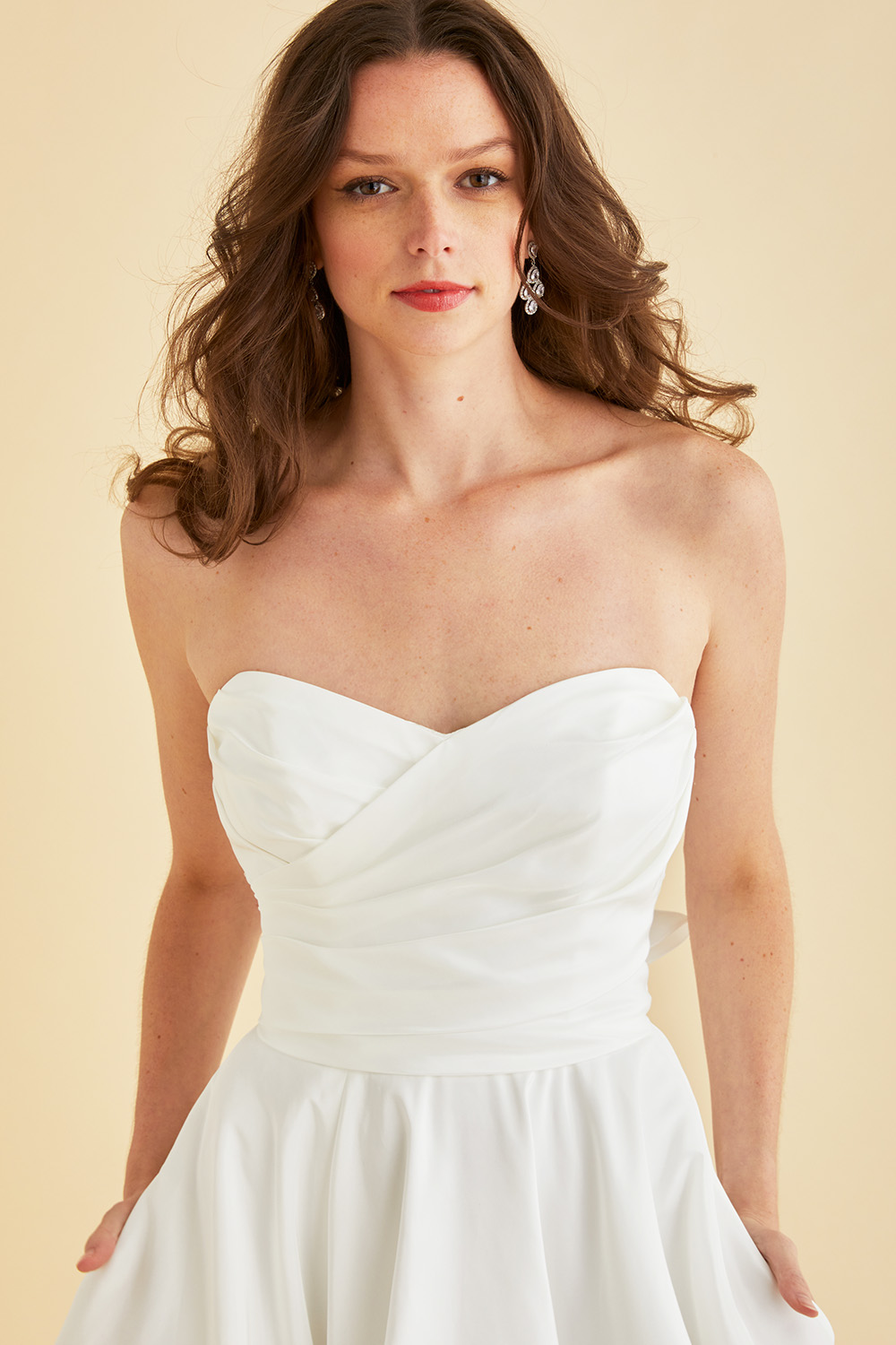Ivory Astrid & Mercedes Jewel wedding gown—sweetheart ruched bodice, A‑line full circle taffeta skirt with pockets, thigh‑high slit, and vertical statement back bow