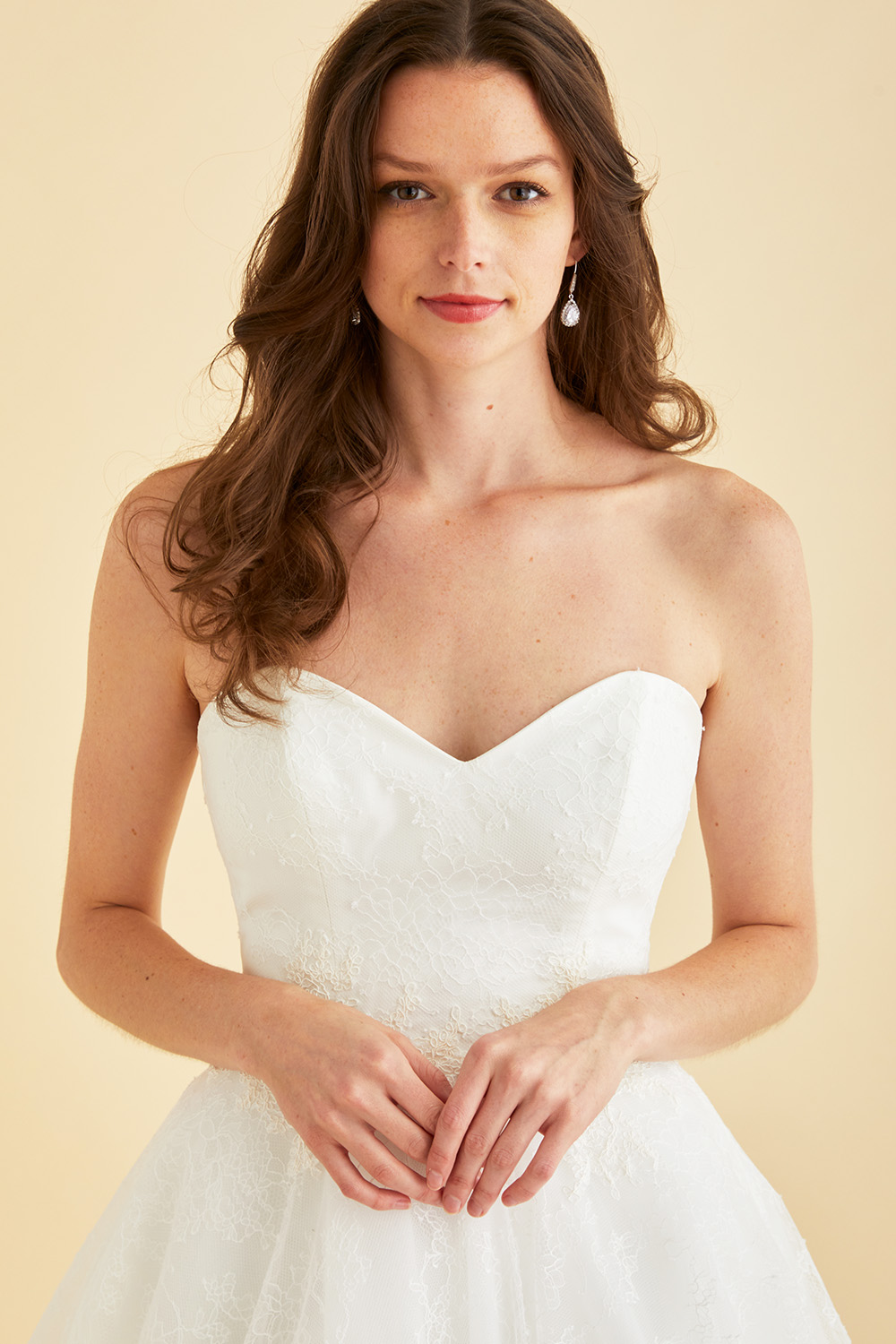 Strapless Astrid & Mercedes Paradise bridal gown by Lea‑Ann Belter in off‑white Chantilly lace, featuring a sweetheart bodice, low open back, natural waist, full circle skirt, and sheer chapel train