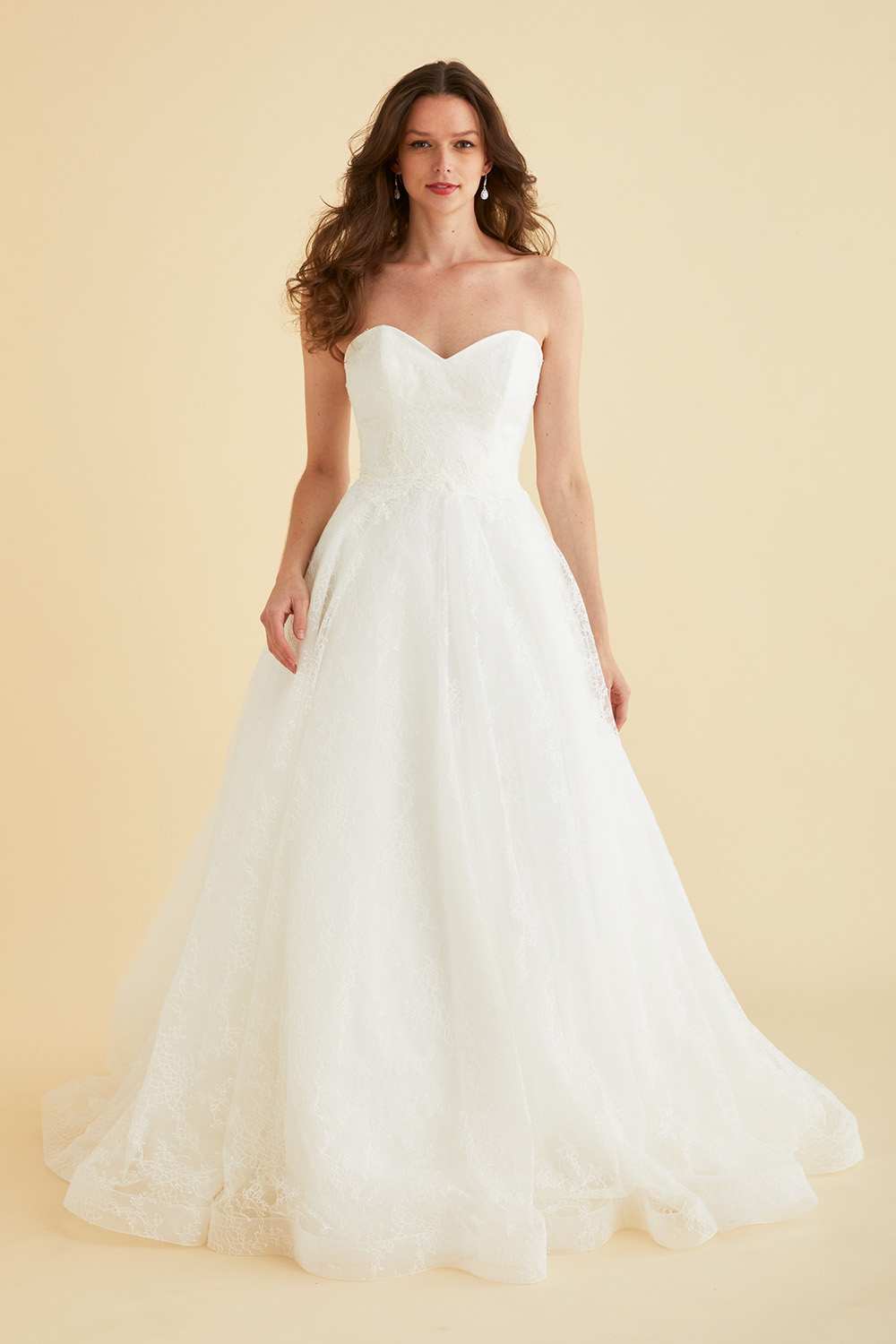 Strapless Astrid & Mercedes Paradise bridal gown by Lea‑Ann Belter in off‑white Chantilly lace, featuring a sweetheart bodice, low open back, natural waist, full circle skirt, and sheer chapel train