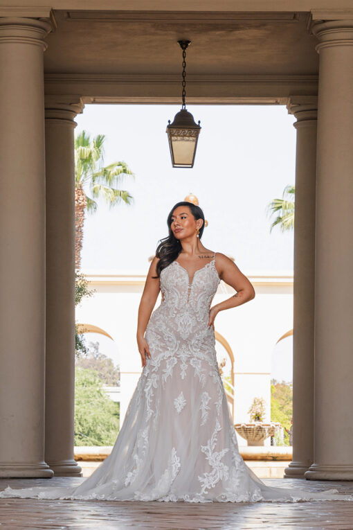 Bride wearing Essense of Australia D3919 fit-and-flare wedding dress with plunging V-neckline and fitted lace bodice