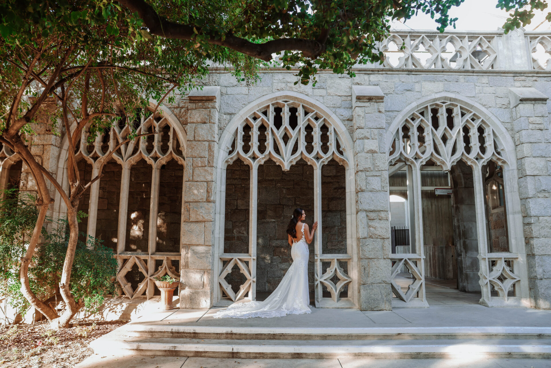 Bride wearing a Bliss Bridal Salon gown standing in front of a historic church in downtown Fort Worth