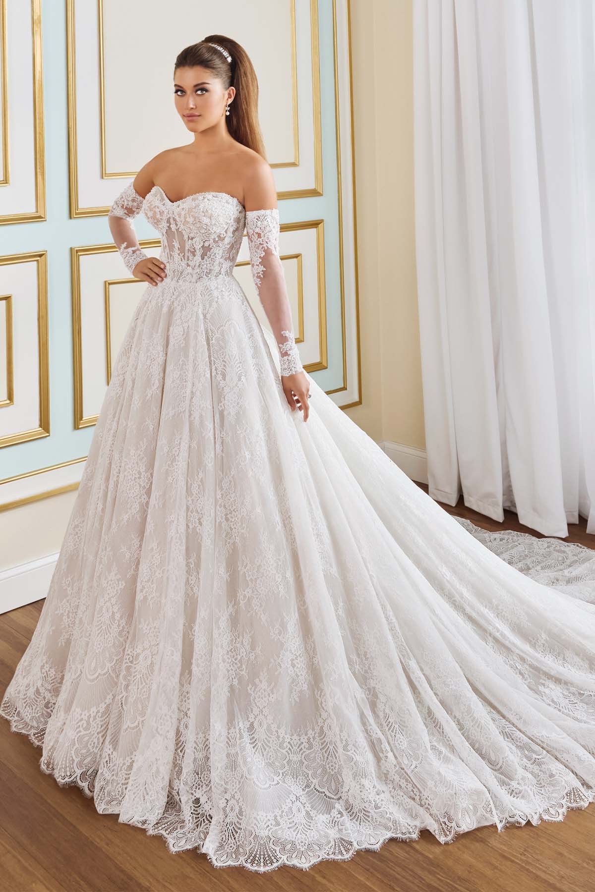 Ivory Martin Thornburg Begonia MT9112 A‑line wedding dress featuring a strapless sweetheart neckline, corded Chantilly lace bodice, glitter tulle skirt, corset waist detail, dramatic train, and separate long illusion sleeves