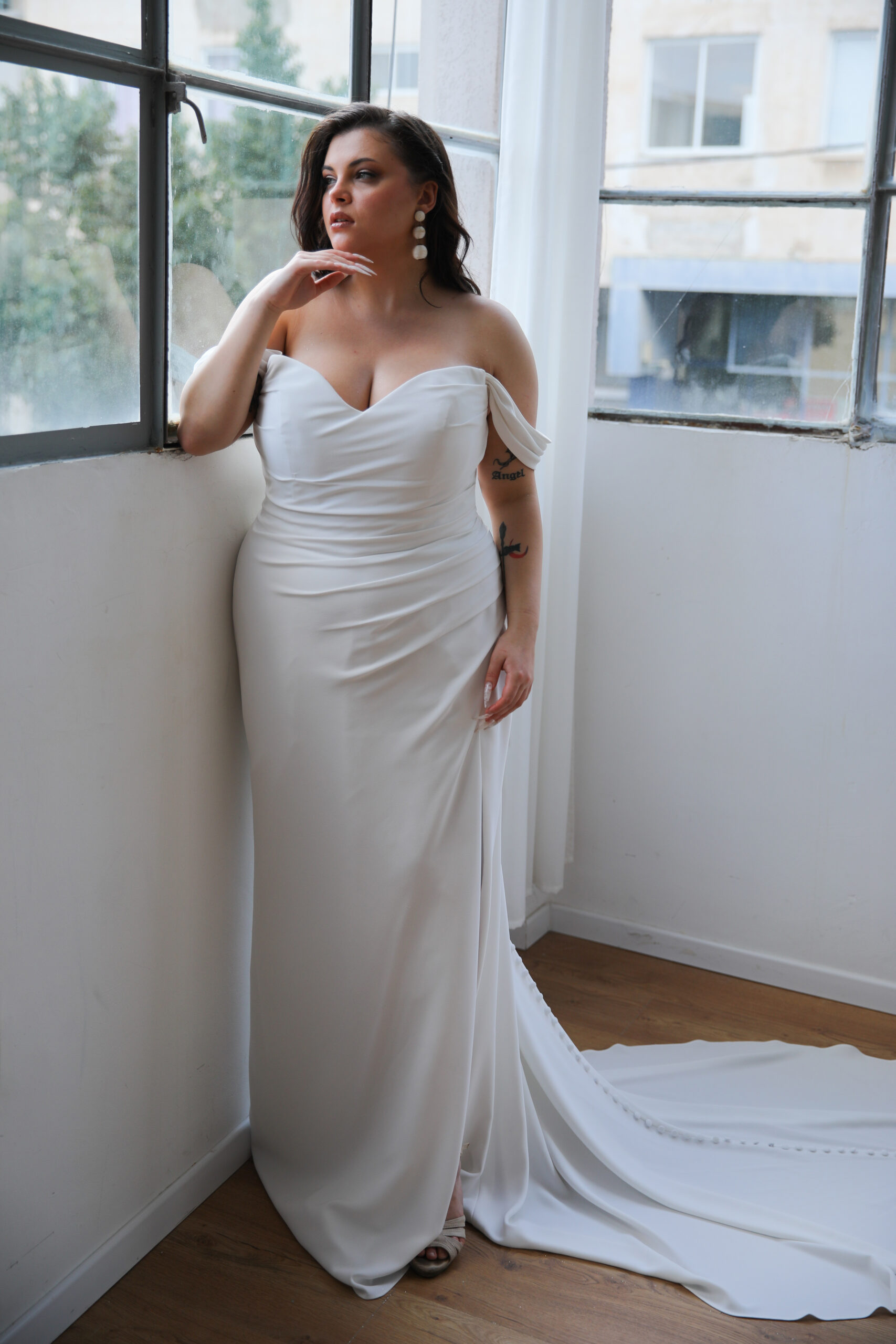 Studio Levana Orchid wedding dress in curve-hugging crepe with draped corset bodice, flattering neckline, and thigh-high slit