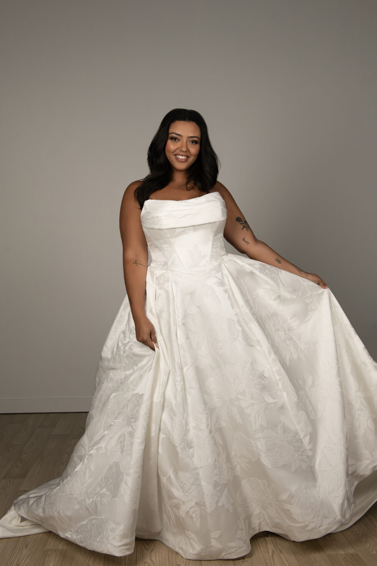 Plus size Stella York wedding dress featuring jacquard fabric, strapless neckline, and full ballgown silhouette