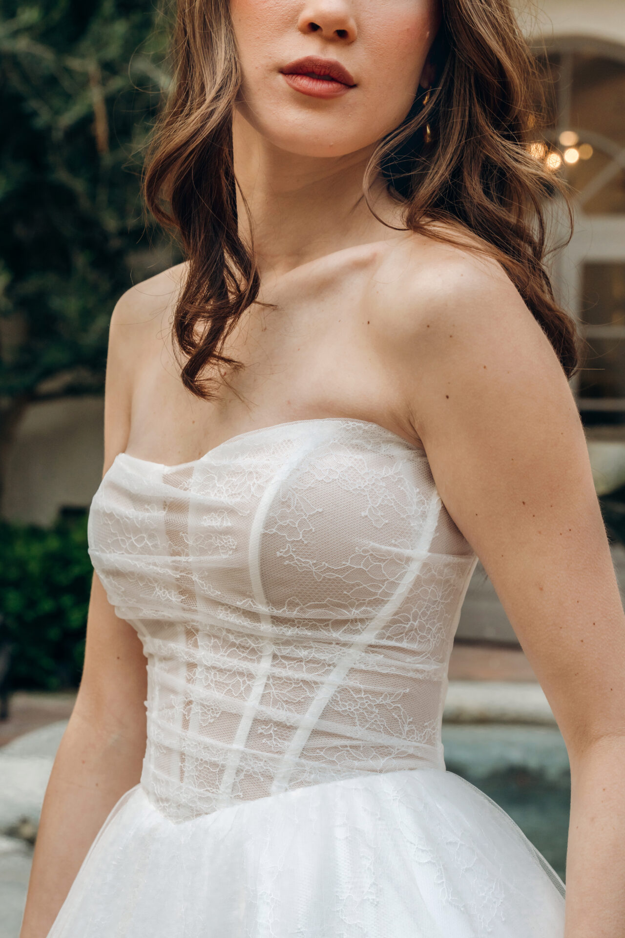 Stella York wedding dress Style SY8087 featuring a strapless ruched bodice, Chantilly lace, and flowing tulle A-line skirt