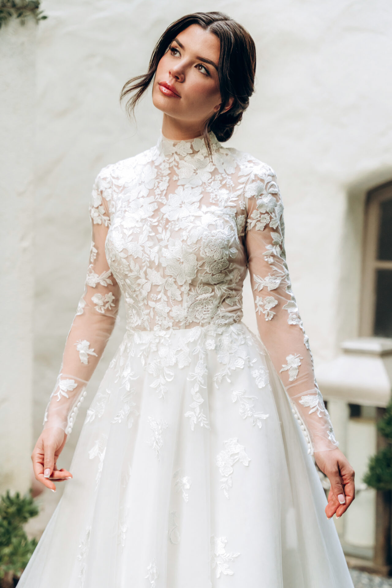 Stella York wedding dress with high neckline, sheer lace bodice, full tulle and organza ballgown skirt, and keyhole back detail