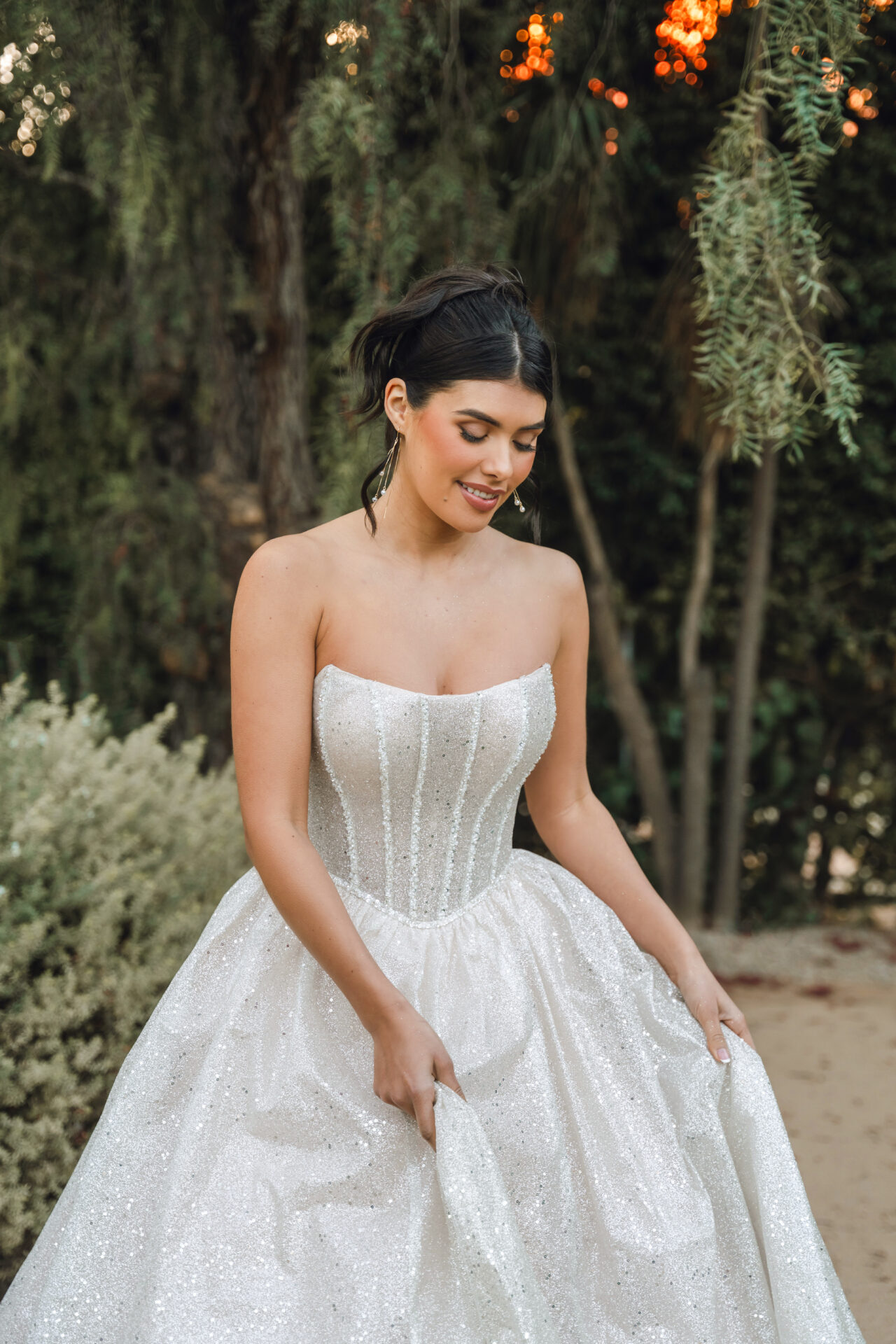 Stella York wedding dress SY8133 featuring a strapless cat-eye neckline, exposed corset bodice, and glittering tulle ballgown skirt