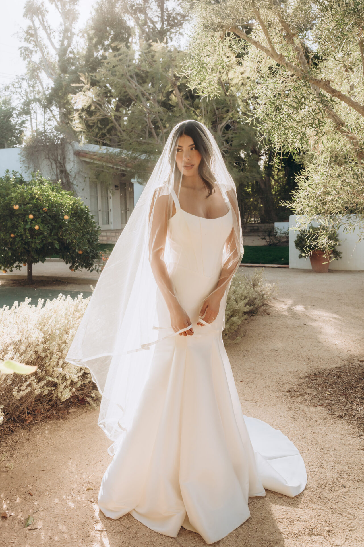 Stella York wedding dress Style SY8148 with modest scoop neckline, wide straps, and a sleek fit-and-flare silhouette