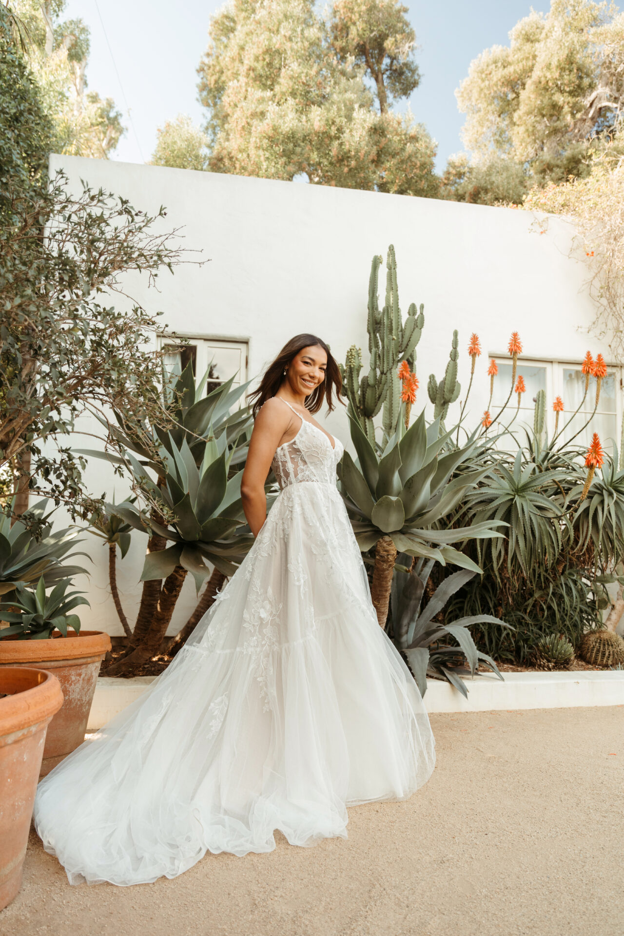 Stella York wedding dress style SY8153 featuring 3D floral lace, sheer bodice, and tiered tulle ballgown skirt
