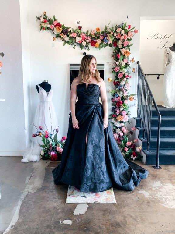 Elegant black jacquard strapless ballgown with a sheer illusion back and dramatic bow detail